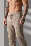 FJØRNA merino wool beige trousers displayed on a model, showcasing their tailored fit and soft fabric for stylish comfort.