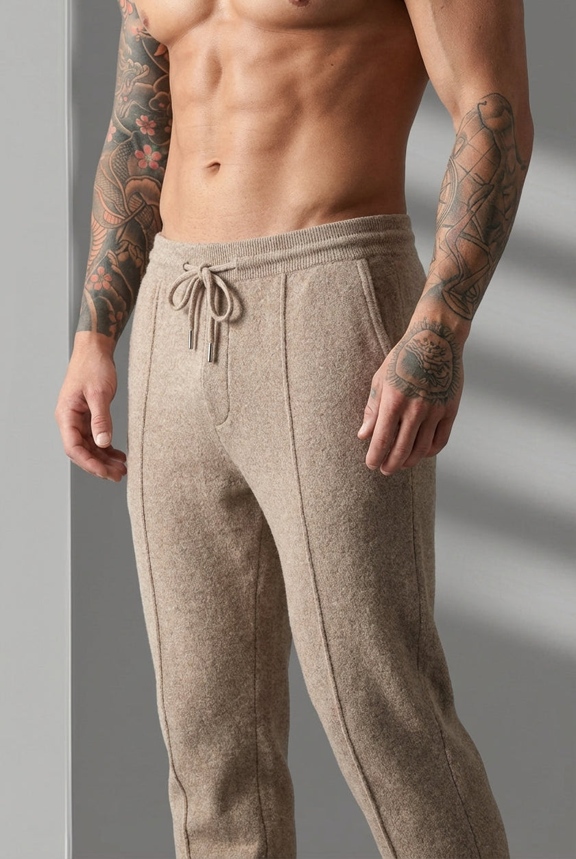 FJØRNA merino wool beige trousers displayed on a model, showcasing their tailored fit and soft fabric for stylish comfort.