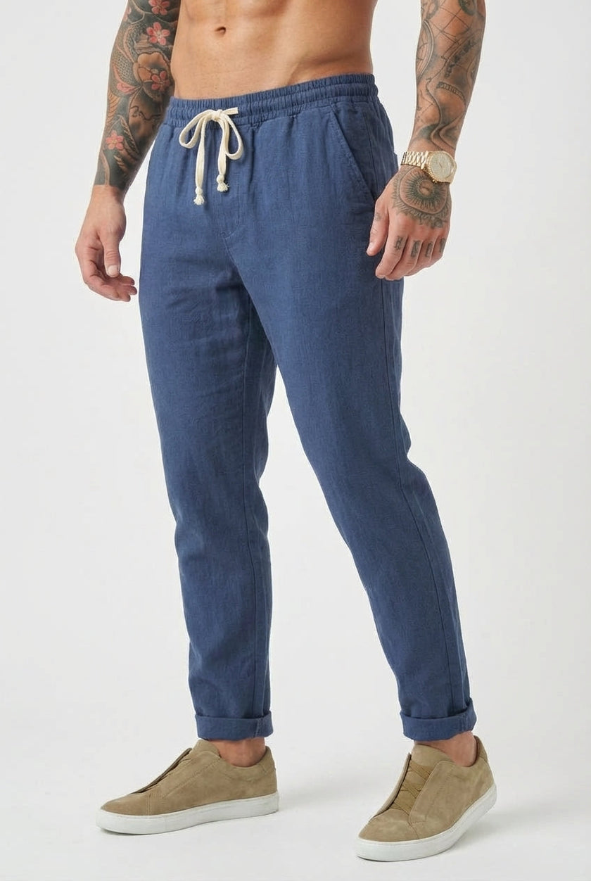 FJØRNA Linen tailored trousers in neutral color, featuring a high waist and sleek fit, displayed on a model.