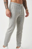 Light grey Merino wool trousers by FJØRNA, featuring a tailored fit and classic design, shown on a model.