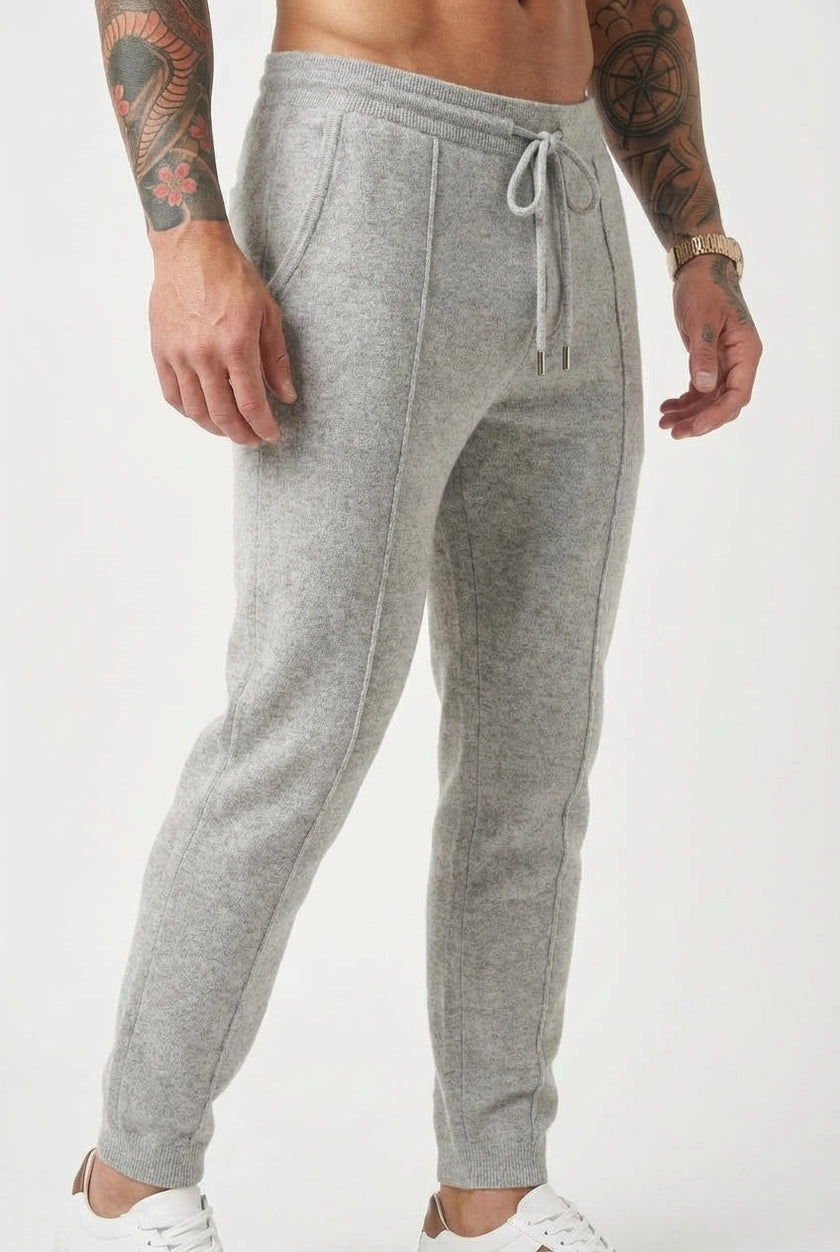 Light grey Merino wool trousers by FJØRNA, featuring a tailored fit and classic design, shown on a model.