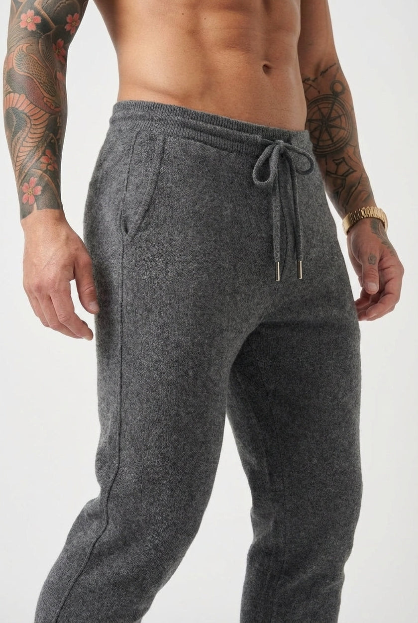 FJØRNA Merino wool trousers in dark grey, tailored fit with waistband and pockets, suitable for casual or office wear.
