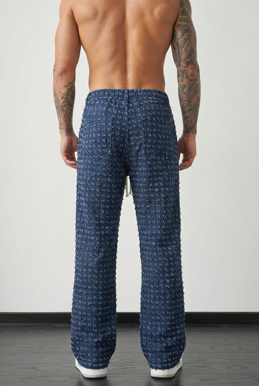 Black distressed trousers by FJØRNA featuring a relaxed fit and rugged, worn-in denim style.