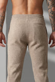 FJØRNA merino wool beige trousers displayed on a model, showcasing a tailored fit and soft, high-quality fabric.