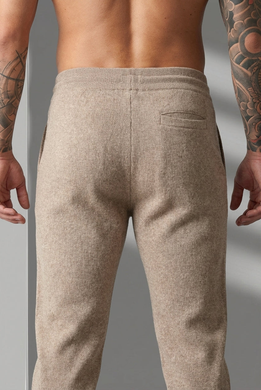 FJØRNA merino wool beige trousers displayed on a model, showcasing a tailored fit and soft, high-quality fabric.