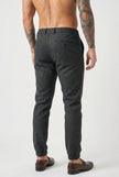 FJØRNA slim-fit black trousers displayed on a model, showcasing their tailored fit and sleek design.