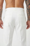 White tailored trousers by FJØRNA, featuring a sleek fit and classic design, shown on a model standing against a neutral background.