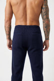 Navy Merino wool trousers by FJØRNA, featuring a tailored fit and smooth fabric, displayed on a neutral background.