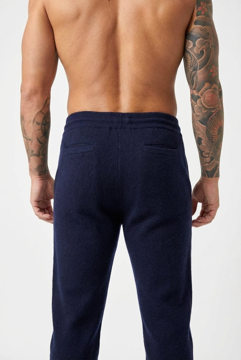 Navy Merino wool trousers by FJØRNA, featuring a tailored fit and smooth fabric, displayed on a neutral background.