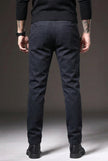 FJØRNA slim-fit blue trousers displayed on a hanger, showcasing tailored fit and modern style for casual or office wear.