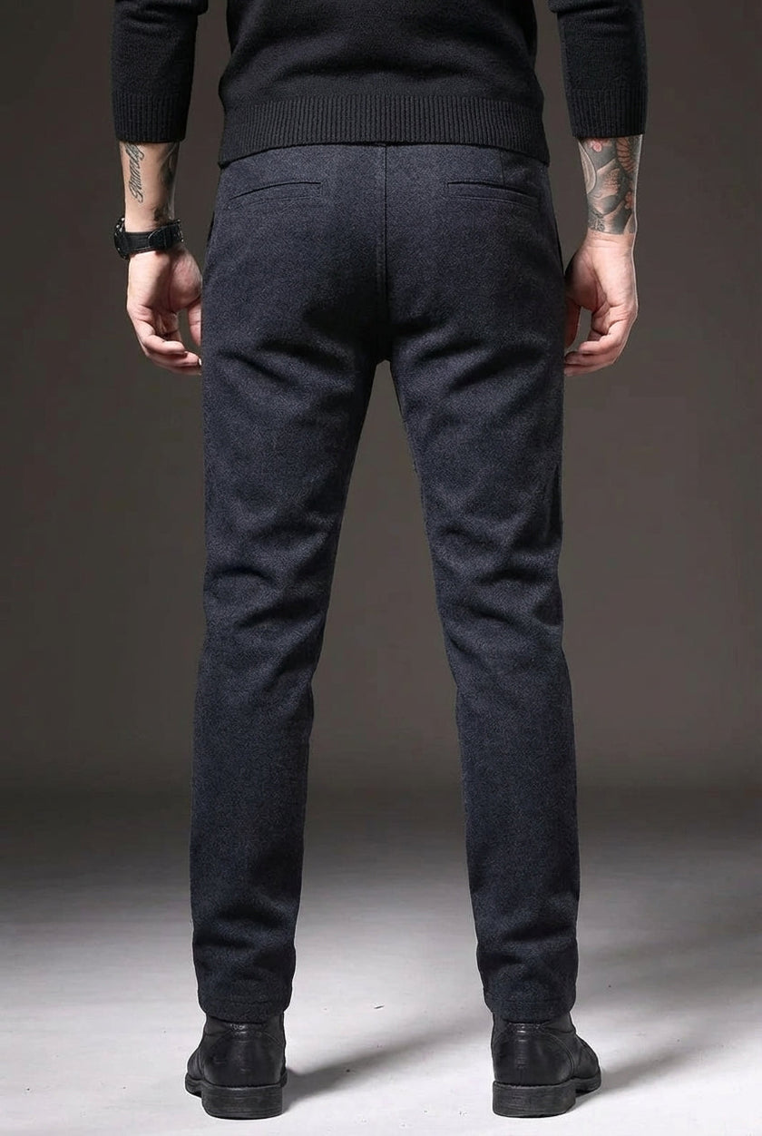 FJØRNA slim-fit blue trousers displayed on a hanger, showcasing tailored fit and modern style for casual or office wear.