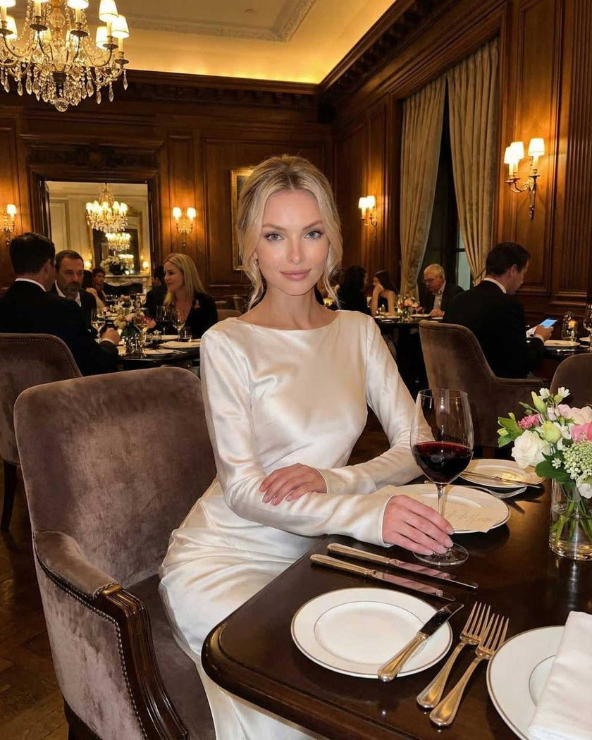 FJØRNA satin maxi dress for women in classic ivory, featuring elegant flowing fabric and modern graceful design.