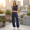 FJØRNA contemporary two-piece wrap-front cropped top and relaxed joggers set, styled in a studio setting.
