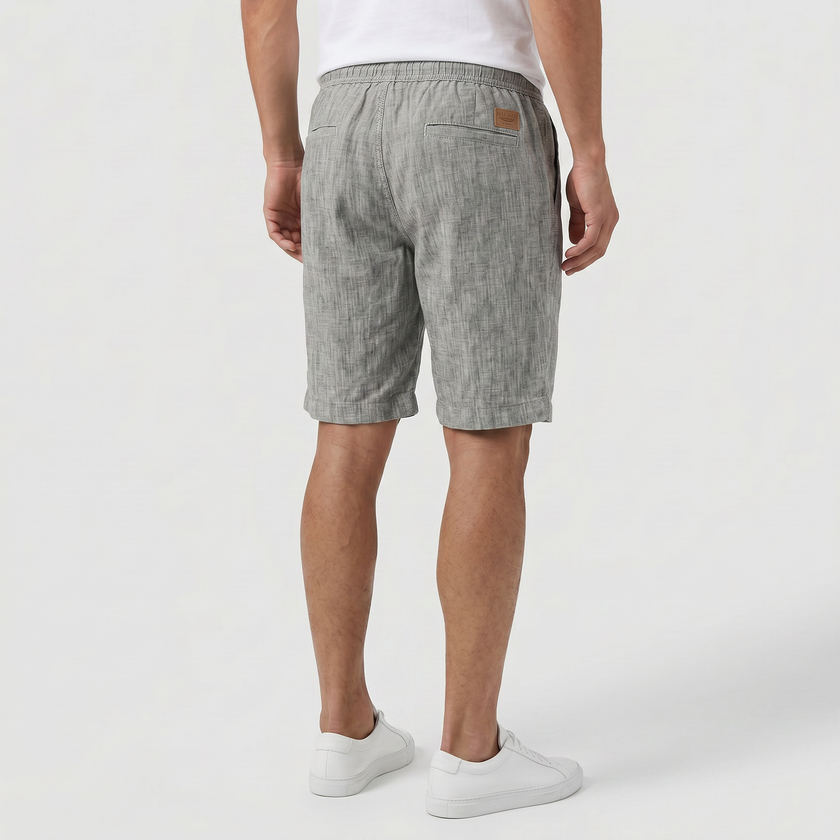 Men's linen shorts by FJØRNA with elasticated waist and drawstring, perfect for summer beachwear and casual outings.