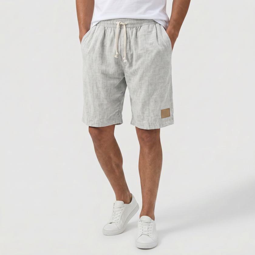Men's linen shorts with elasticated waist and drawstring by FJØRNA, perfect for summer beachwear and casual outings.