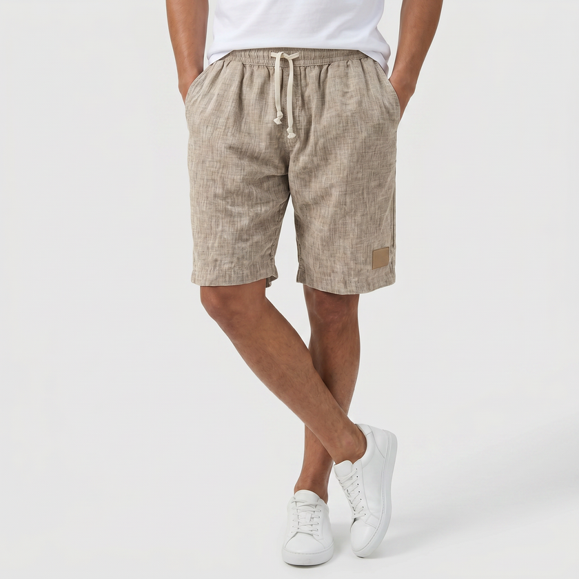 FJØRNA men's linen shorts with elasticated waist and drawstring, perfect for summer beachwear and casual outings.