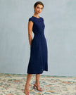 FJØRNA polka dot midi dress for women with a round neck and cutout design, stylish and perfect for casual or semi-formal wear.
