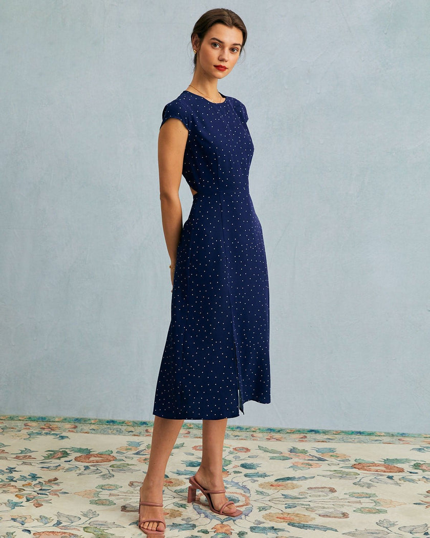 FJØRNA polka dot midi dress for women with round neckline and cutout details, showcasing a stylish and elegant dress design.