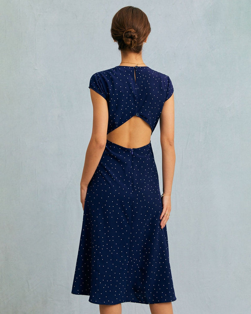 FJØRNA women's polka dot midi dress with round neckline and cutout details, showcasing a stylish and feminine dress design.