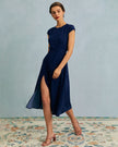 FJØRNA women's polka dot midi dress with round neckline and cutout detail, featuring a stylish and elegant design.