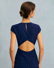 FJØRNA polka dot midi dress for women with a round neck and cutout details, showcasing the stylish, feminine design.