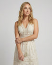 FJØRNA bohemian lace maxi dress with tiered skirt and tassel waist, featuring intricate lace details and flowing silhouette.