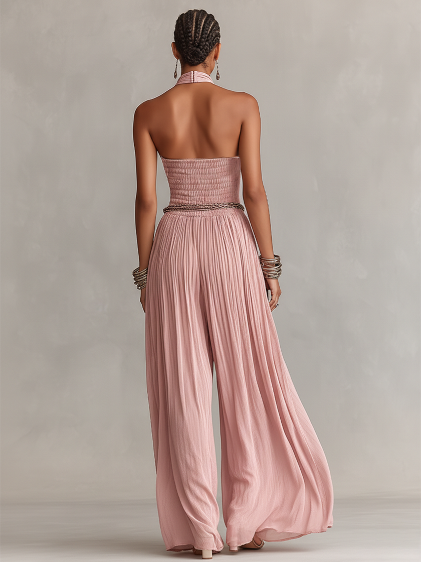 FJØRNA blush pleated jumpsuit for women with halter neck, ruched waist, and wide-leg pants, stylish and elegant.
