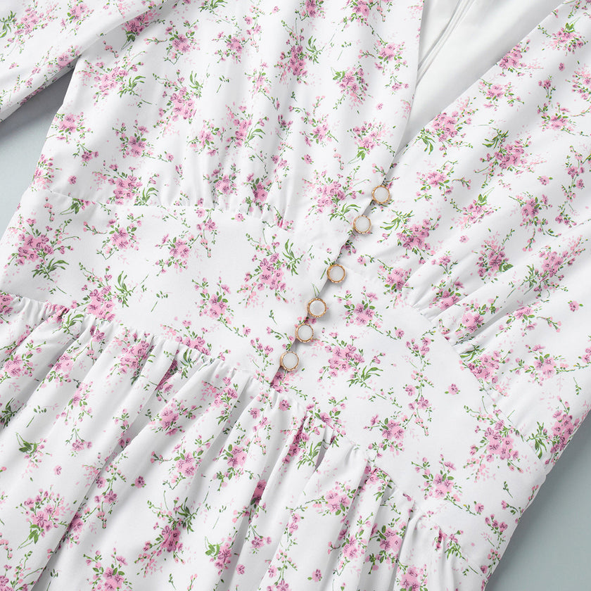 FJØRNA white floral V-neck mini dress with lantern sleeves, featuring a detailed view of the elegant floral pattern.