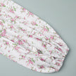 FJØRNA V-neck white floral mini dress with lantern sleeves, detailed close-up of the elegant floral pattern and sleeve design.