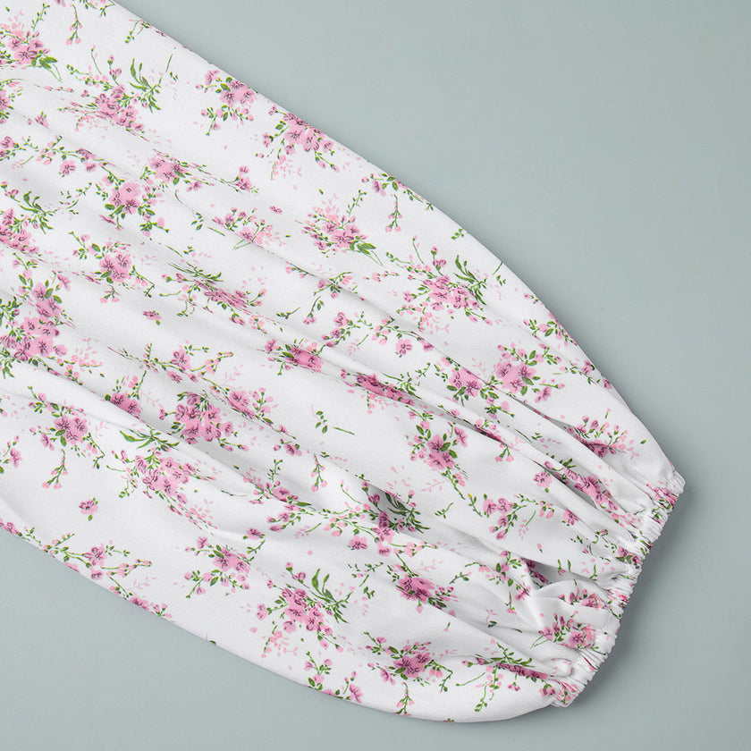 FJØRNA V-neck white floral mini dress with lantern sleeves, detailed close-up of the elegant floral pattern and sleeve design.