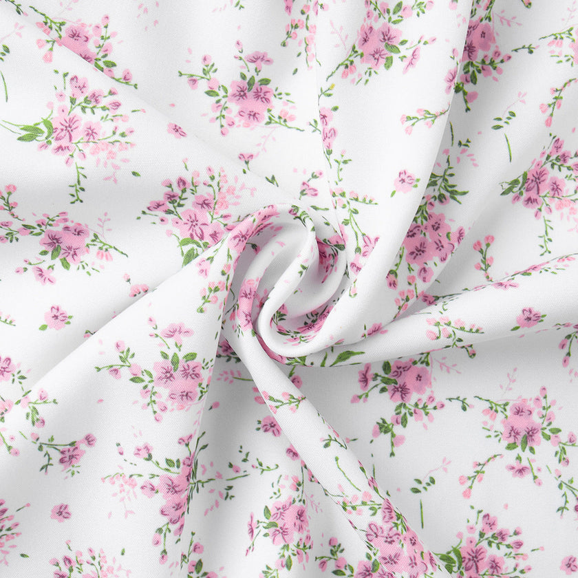 FJØRNA V-neck white floral mini dress with lantern sleeves, featuring a detailed close-up of the floral pattern and elegant design.