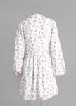 FJØRNA V-neck white floral mini dress with lantern sleeves, shown from the back, perfect for spring and summer occasions.