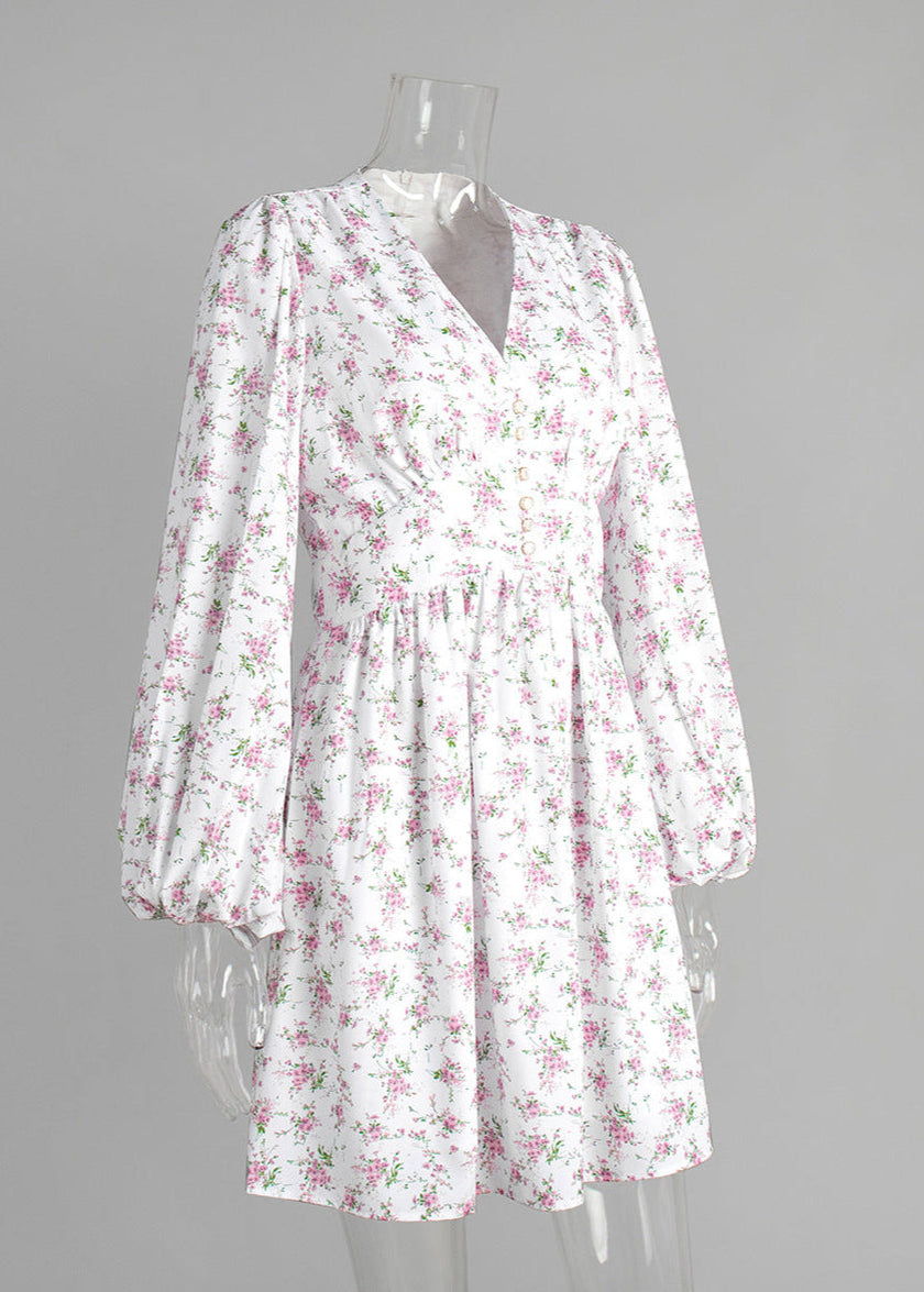 FJØRNA V-neck white floral mini dress with lantern sleeves, featuring a fitted bodice and delicate floral pattern.