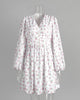 FJØRNA white floral V-neck mini dress with lantern sleeves, showcasing a stylish and feminine summer dress design.