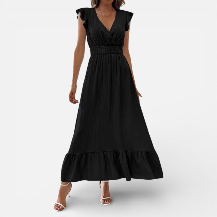 Women's sleeveless maxi dress by FJØRNA featuring a flowy fit and timeless style, shown in a relaxed, elegant design.