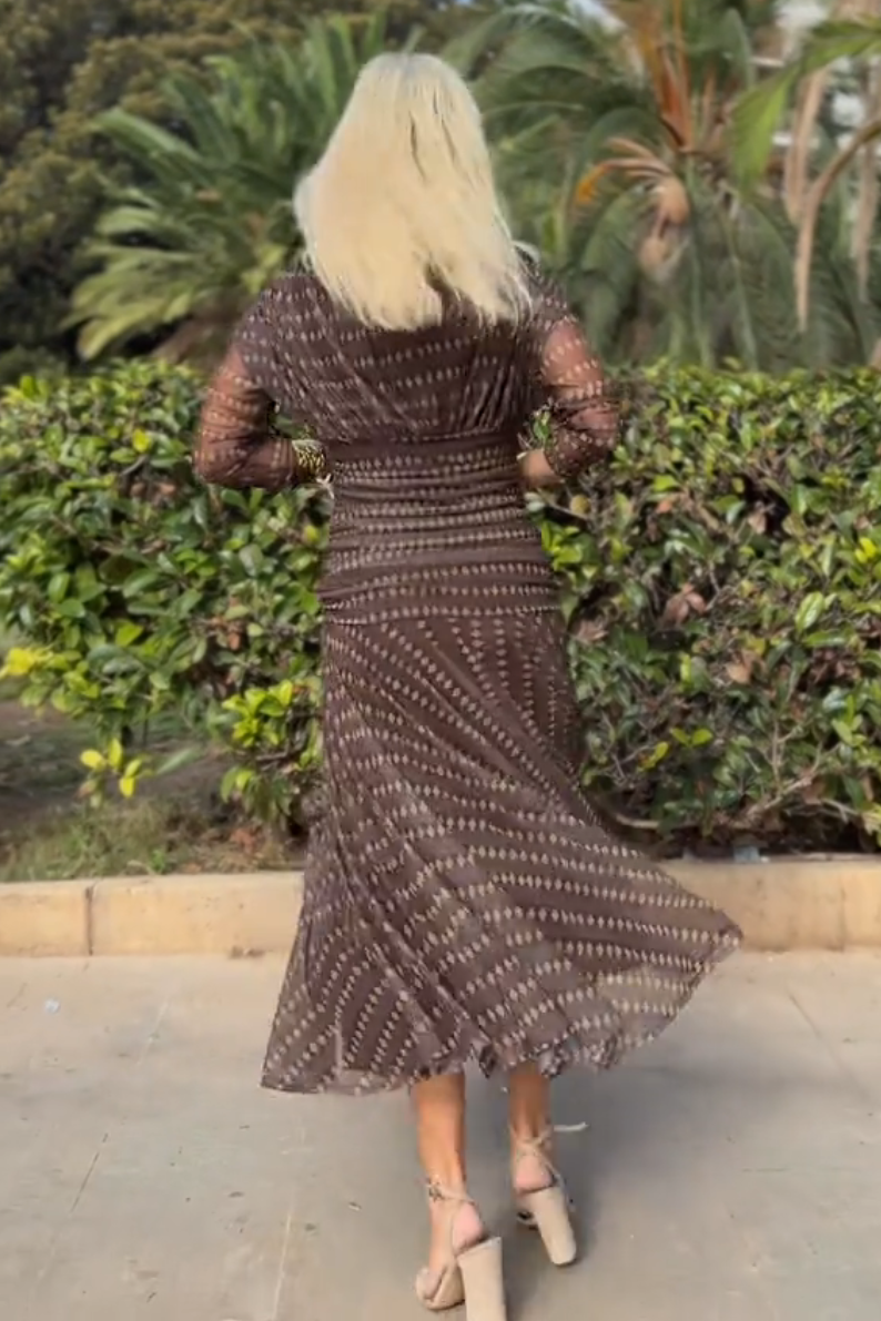 FJØRNA bohemian patterned V-neck mesh maxi dress with flowing silhouette and vibrant ethnic print, perfect for boho style occasions.