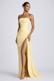 Yellow women's strapless maxi dress with ruched waist by FJØRNA, featuring flowing fabric and elegant design for special occasions.