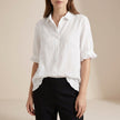 FJØRNA women's white denim summer blouse with ruffle details, casual style, short sleeves, and a relaxed fit.
