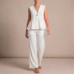 White women's two-piece summer set by FJØRNA with wide-leg pants and V-neck top, perfect for warm weather.