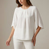 White pleated summer blouse for women by FJØRNA, casual top with a relaxed fit and lightweight fabric.