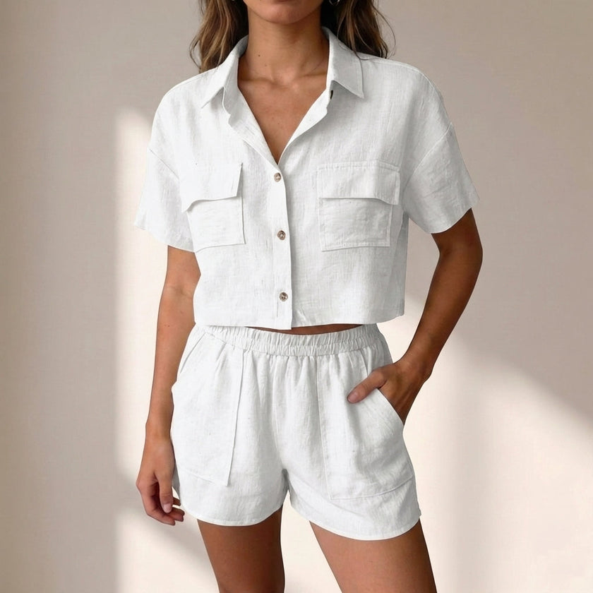 FJØRNA relaxed white two-piece shorts set with collared top and matching shorts in lightweight textured woven fabric.