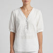 White FJØRNA women's summer blouse with V-neck, short sleeves, and linen fabric, casual and breathable for warm weather.