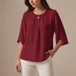 Wine red FJØRNA summer blouse for women with pleated casual design, featuring a relaxed fit and stylish neckline.