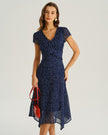Navy blue polka dot chiffon midi dress for women with V-neck, tiered ruffle short sleeves, by FJØRNA.