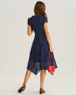 Navy blue polka dot chiffon midi dress for women with V-neck, tiered ruffles, and short sleeves by FJØRNA.