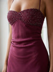 Women's satin halter maxi dress by FJØRNA featuring beaded details and elegant formal design.