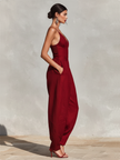 FJØRNA women's linen spaghetti strap jumpsuit with V-neck, high waist, pleated details, and wide-leg pants, shown in XS.