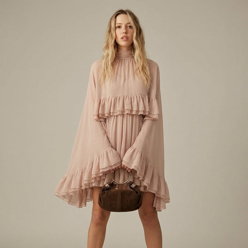 FJØRNA ruffle chiffon mini dress with high neckline and layered fit, shown from the front in salmon color.