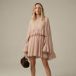 FJØRNA ruffle chiffon mini dress with high neck and layered fit, shown from the front in salmon color.