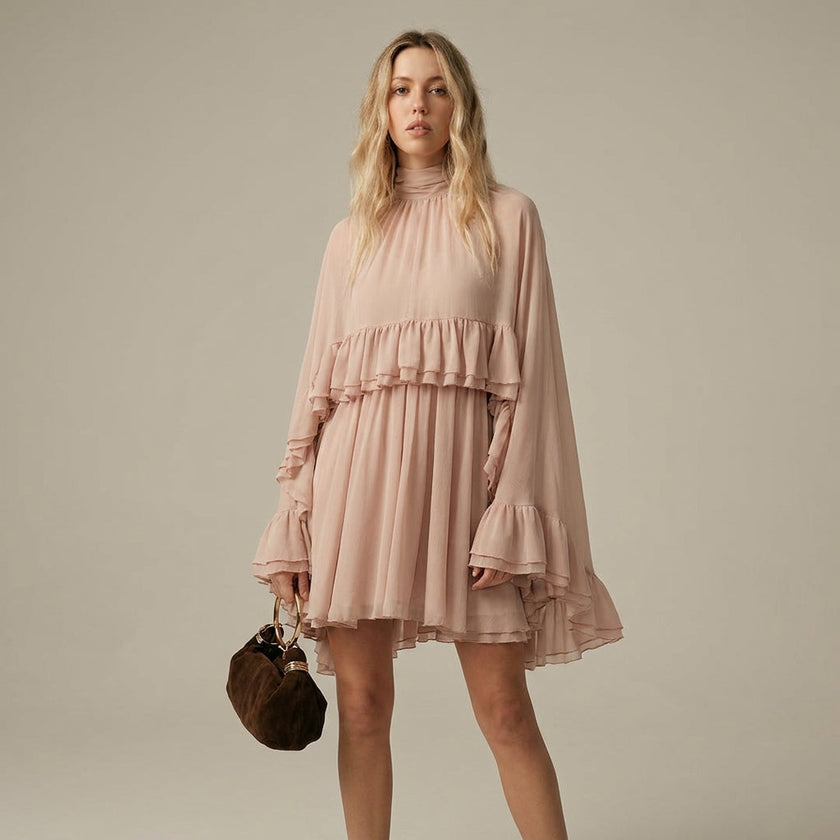 FJØRNA ruffle chiffon mini dress with high neck and layered fit, shown from the front in salmon color.